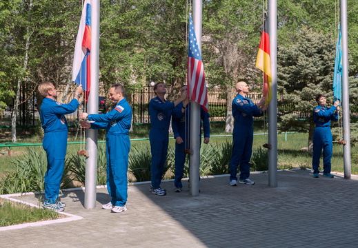 11-04-30 At the Cosmonaut Hotel crew quarters in Baikonur, Kazakhstan, the Expedition 40 41 prime and backup crewmembers raise the flags of Russia, the United States, Germany and Kazakhstan during traditional ce o