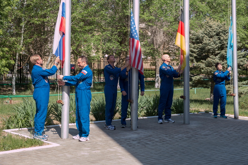 11-04-30_At the Cosmonaut Hotel crew quarters in Baikonur, Kazakhstan, the Expedition 40_41 prime and backup crewmembers raise the flags of Russia, the United States, Germany and Kazakhstan during traditional ce_o.jpg