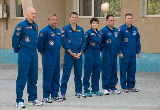 11-07-03 At the Cosmonaut Hotel crew quarters in Baikonur, Kazakhstan, the Expedition 40 41 prime and backup crewmembers pose for pictures after raising the flags of Russia, the United States, Germany and Kazakh o