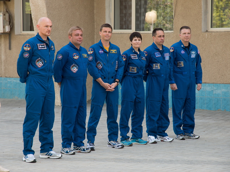 11-07-03_At the Cosmonaut Hotel crew quarters in Baikonur, Kazakhstan, the Expedition 40_41 prime and backup crewmembers pose for pictures after raising the flags of Russia, the United States, Germany and Kazakh_o.jpg