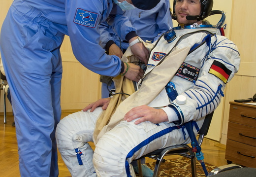 12-01-15-4 At the Baikonur Cosmodrome in Kazakhstan, Expedition 40 41 Flight Engineer Alexander Gerst of the European Space Agency suits up in his Russian Sokol launch and entry suit May 16 for a dress rehearsal o