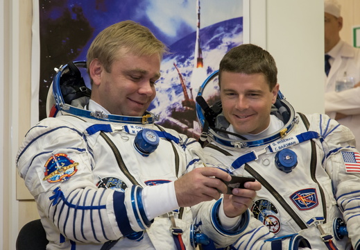 12-37-47-2 At the Baikonur Cosmodrome in Kazakhstan, Expedition 40 41 Soyuz Commander Max Suraev of the Russian Federal Space Agency (Roscosmos, left) and NASA Flight Engineer Reid Wiseman (right) look at pictur o