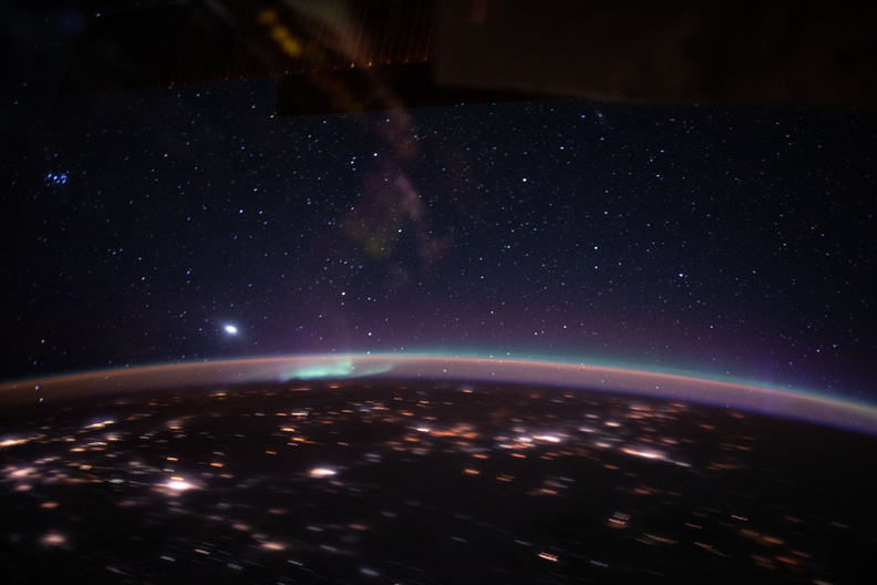 an-aurora-accents-earths-atmospheric-glow-underneath-a-starry-sky_49676279953_o.jpg