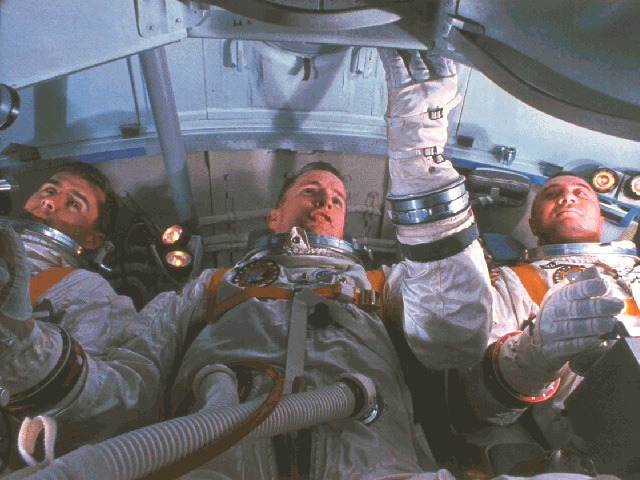 Astronauts for the first Apollo Mission practice for the mission in the Apollo Mission Simulator